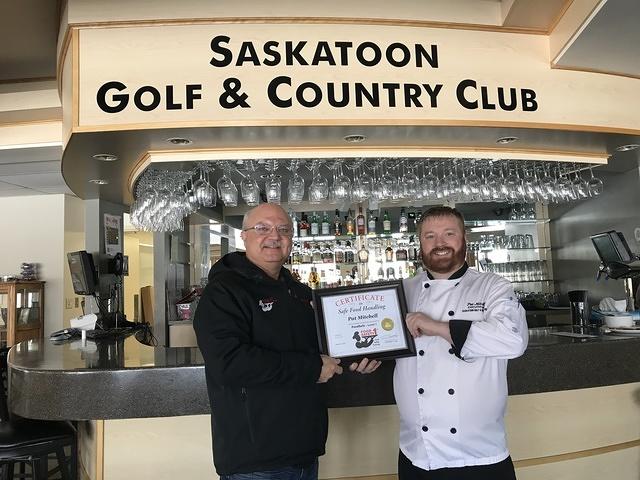 Food Safety 1st, Russell Scott presents Pat Mitchell the 12,000th Food Safety 1st certificate