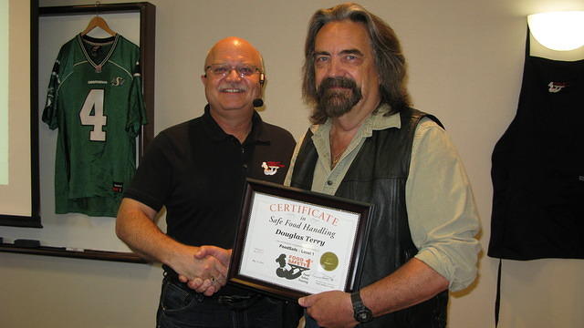 Food Safety 1st, Russell Scott presents Douglas Terry from Melfort, Sk. the 9,000th Food Safety 1st certificate!