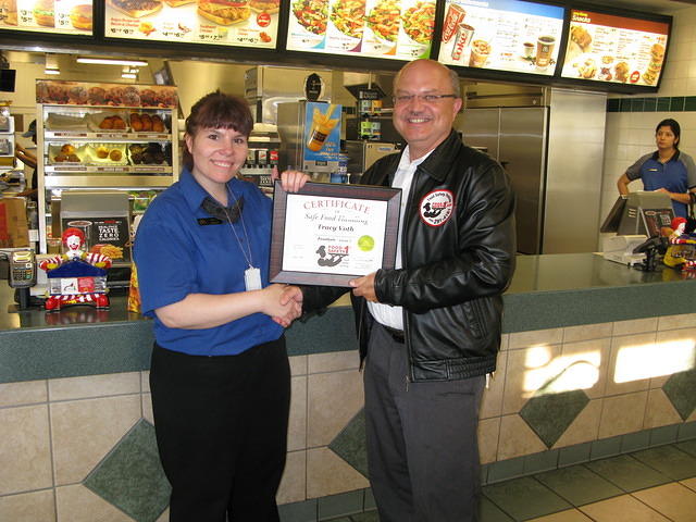 Food Safety 1st, Russell Scott presents Tracy Voth of McDonald's the 1000th Food Safety 1st Certificate!