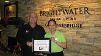 Food Safety 1st, Russell Scott presents Rose Marilou Delos Santos of Brightwater Sr Living the 8,000th Food Safety 1st certificate
