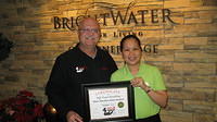 Food Safety 1st, Russell Scott presents Rose Marilou Delos Santos of Brightwater Sr Living the 8,000th Food Safety 1st certificate!