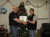 Russell Scott presents Rhonda Gardiner of Cheshire Homes of Saskatoon the 7,000th Food Safety 1st certificate.
