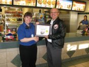 Russell Scott presents Tracy Voth of McDonalds Restaurant the 1,000th Food Safety 1st certificate.